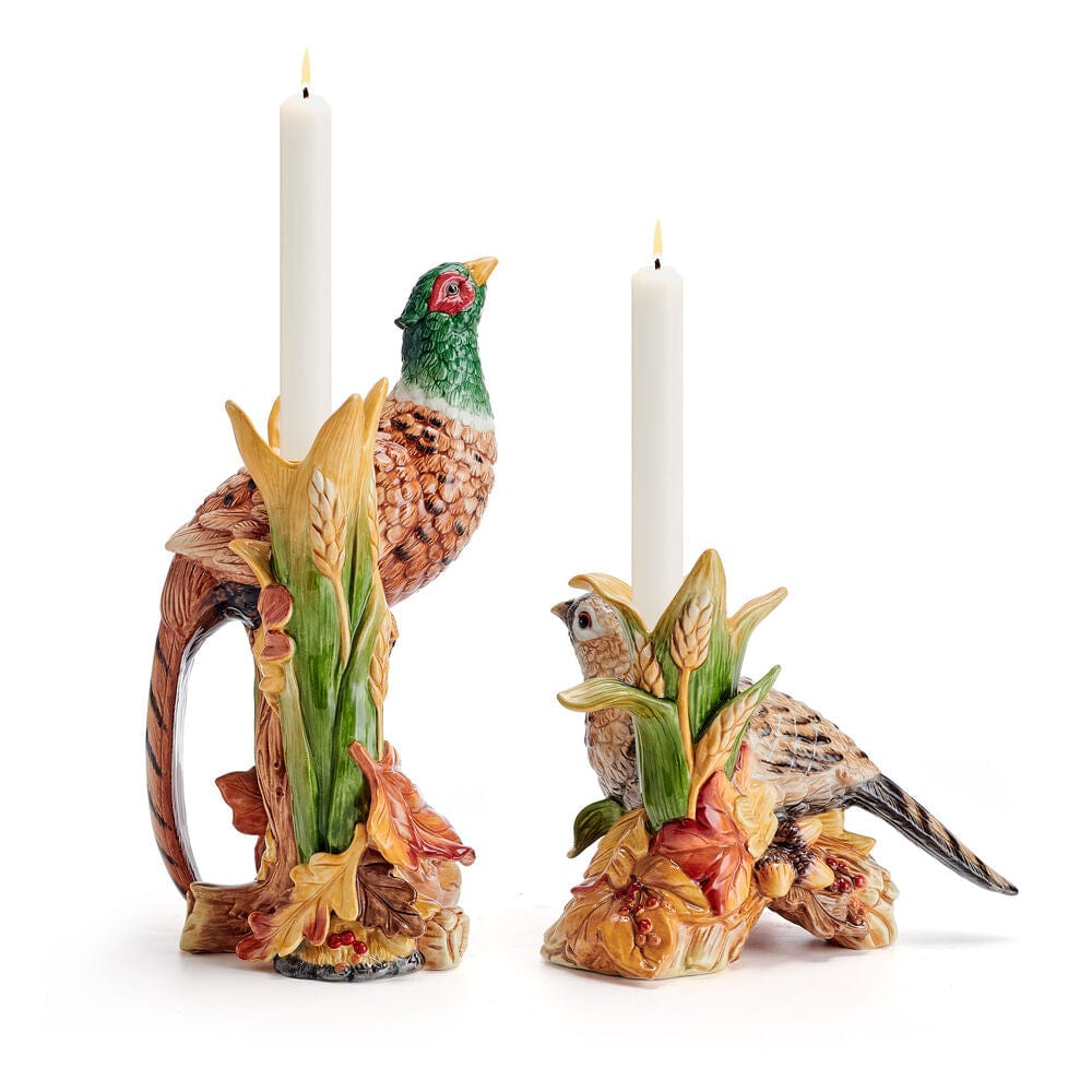 Two pheasant figurine candleholders with tall white taper candles
