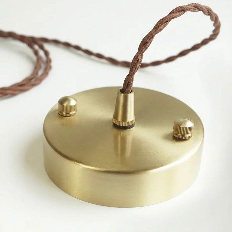Textured Ceramic Pendant Light with Brass Details and Warm Lighting