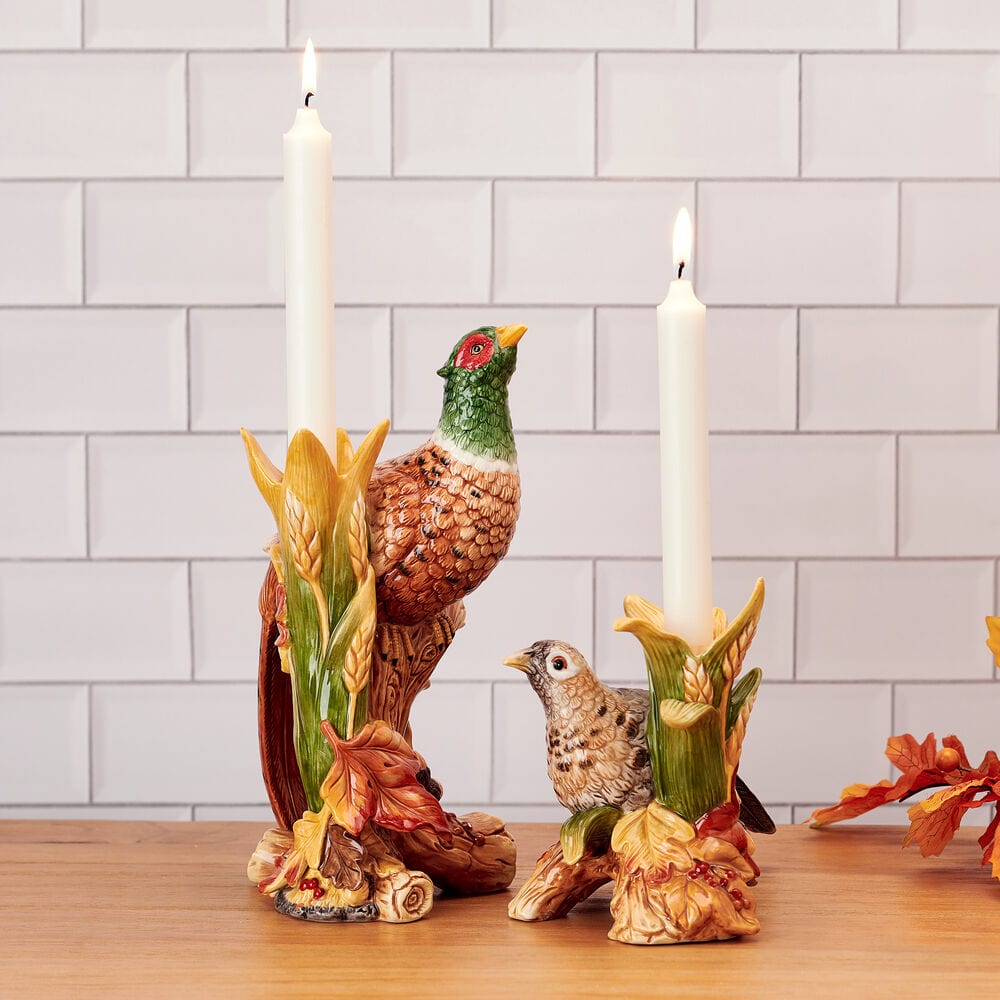 Pheasant figurine candleholders set of 2 with white taper candles against a tiled backdrop
