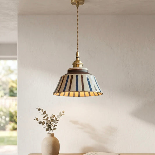 Textured Ceramic Pendant Light with Brass Details and Warm Lighting