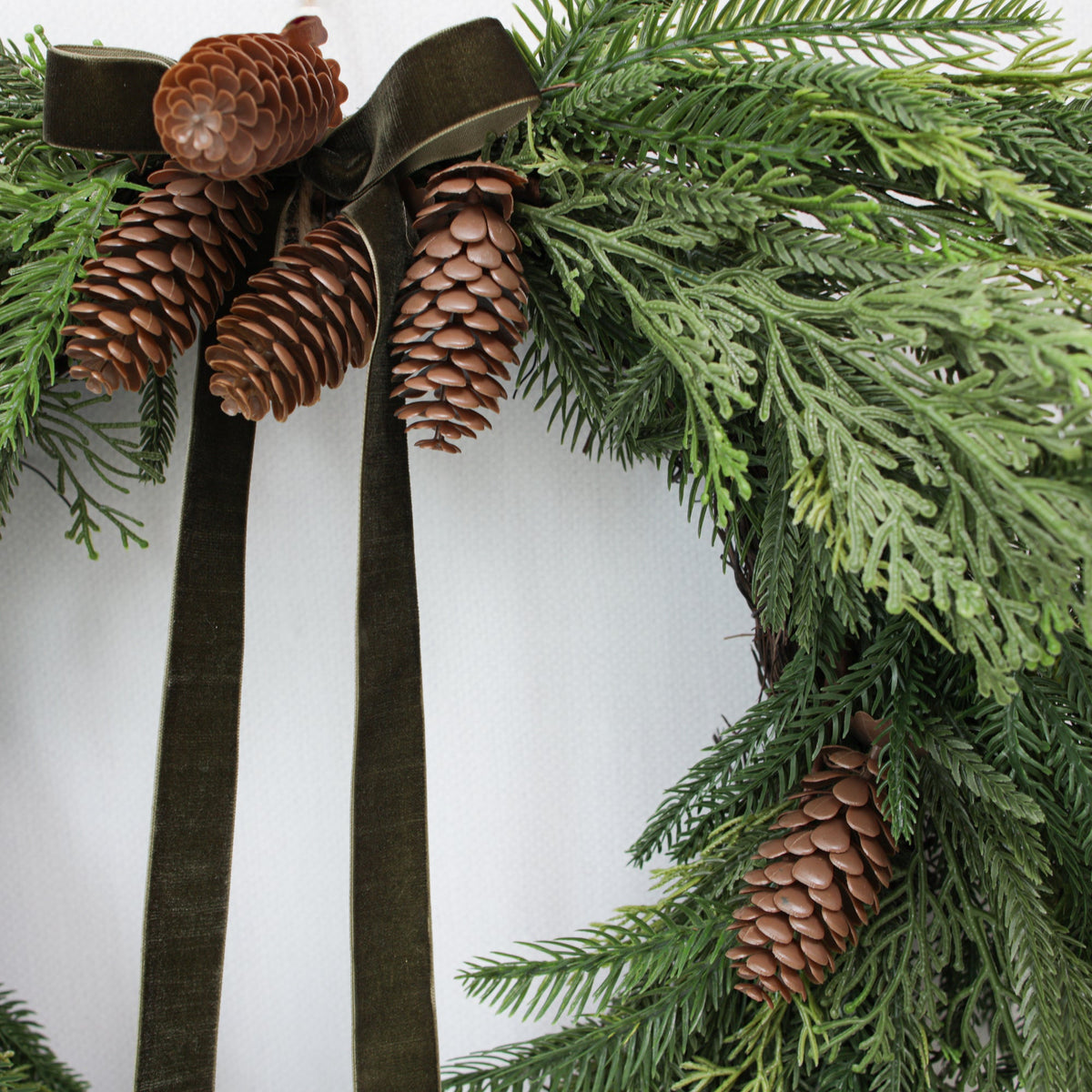 Heart Shaped Pine Wreath with Pinecone Accents and Hunter Green Ribbon